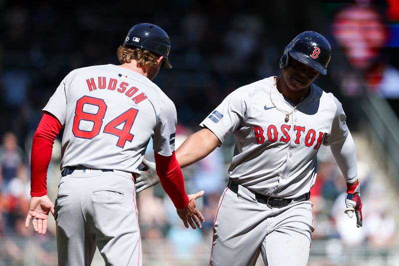 May 5, 2024; Minneapolis, Minnesota, USA; Boston Red Sox Rafael Devers (11) celebrates his two-run home run against the Minnesota Twins during the eighth inning at Target Field. Mandatory Credit: Matt Krohn-USA TODAY Sports