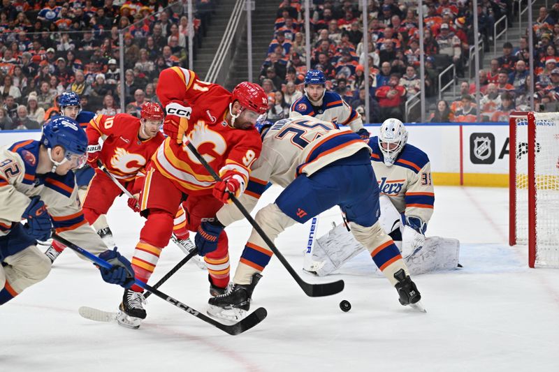 Dec 23, 2025; Edmonton, Alberta, CAN; Calgary Flames center Nazem Kadri (91) battles with Edmonton Oilers Darnell Nurse (25) in front of Calgary Flames goalie Dustin Wolf (32) during the second period at Rogers Place. Mandatory Credit: Walter Tychnowicz-Imagn Images