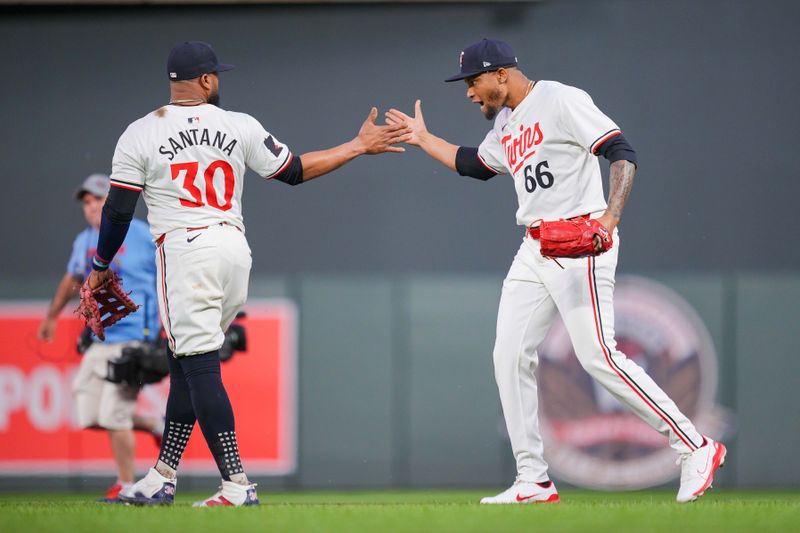 Jun 13, 2024; Minneapolis, Minnesota, USA; Minnesota Twins pitcher Jorge Alcala (66) celebrates with first base Carlos Santana (30)after the game against the Oakland Athletics at Target Field. Mandatory Credit: Brad Rempel-USA TODAY Sports