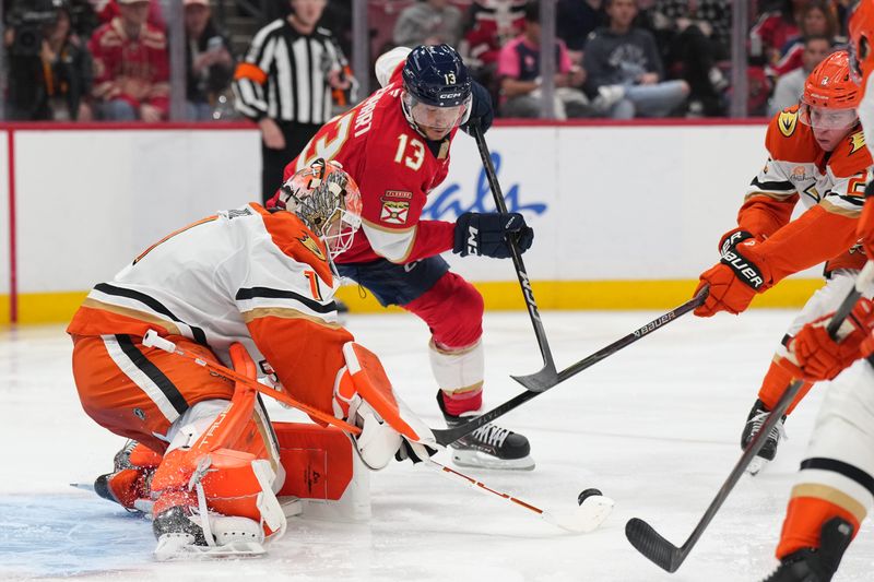Oct 28, 2025; Sunrise, Florida, USA; Anaheim Ducks goaltender Lukas Dostal (1) makes a save as Florida Panthers center Sam Reinhart (13) closes in during the second period at Amerant Bank Arena. Mandatory Credit: Jim Rassol-Imagn Images