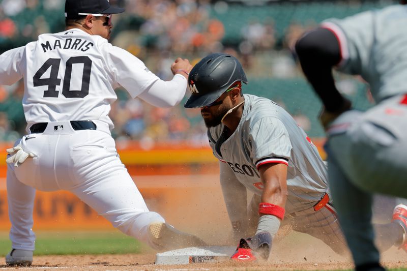 Jul 28, 2024; Detroit, Michigan, USA;  Minnesota Twins second baseman Willi Castro (50) dive back to first in the seventh inning against the Detroit Tigers at Comerica Park. Mandatory Credit: Rick Osentoski-USA TODAY Sports