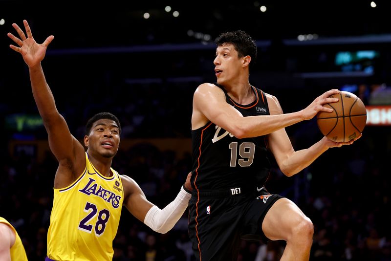 LOS ANGELES, CALIFORNIA - FEBRUARY 13: Simone Fontecchio #19 of the Detroit Pistons looks to pass against Rui Hachimura #28 of the Los Angeles Lakers during the third quarter at Crypto.com Arena on February 13, 2024 in Los Angeles, California. NOTE TO USER: User expressly acknowledges and agrees that, by downloading and or using this photograph, user is consenting to the terms and conditions of the Getty Images License Agreement.  (Photo by Katelyn Mulcahy/Getty Images)