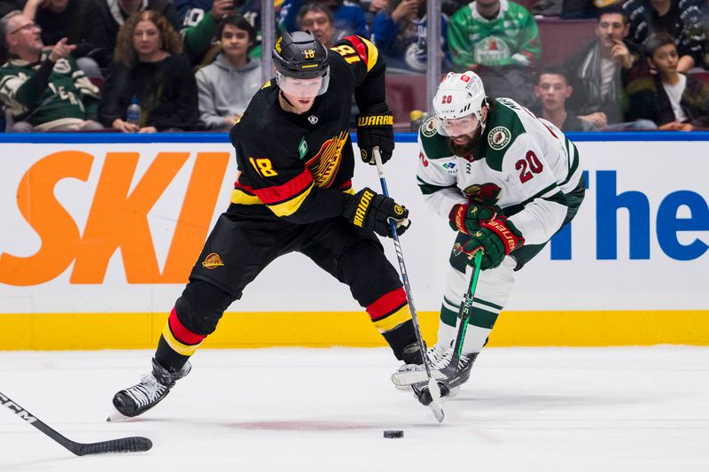 Dec 7, 2023; Vancouver, British Columbia, CAN; Minnesota Wild forward Pat Maroon (20) stick checks Vancouver Canucks forward Sam Lafferty (18) in the third period at Rogers Arena. Vancouver won 2-0. Mandatory Credit: Bob Frid-USA TODAY Sports