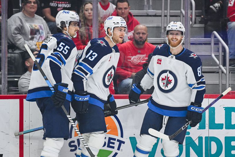 Oct 30, 2024; Detroit, Michigan, USA; Winnipeg Jets center Gabriel Vilardi (13) celebrates his goal with center Mark Scheifele (55) and left wing Kyle Connor (81) during the first period against the Detroit Red Wings at Little Caesars Arena. Mandatory Credit: Tim Fuller-Imagn Images