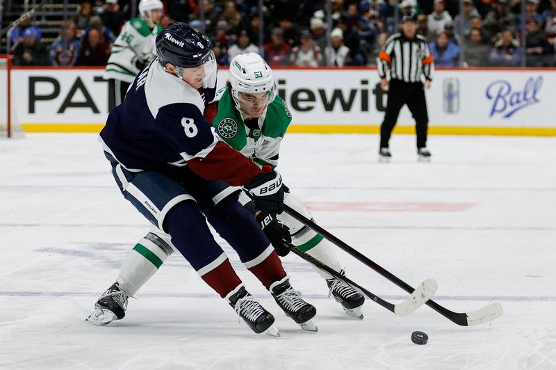 Jan 18, 2025; Denver, Colorado, USA; Colorado Avalanche defenseman Cale Makar (8) and Dallas Stars center Wyatt Johnston (53) battle for the puck in the first period at Ball Arena. Mandatory Credit: Isaiah J. Downing-Imagn Images