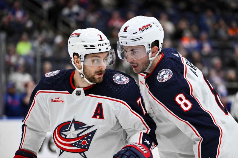 Dec 7, 2023; Elmont, New York, USA; Columbus Blue Jackets center Sean Kuraly (7) and Columbus Blue Jackets defenseman Zach Werenski (8) talk during the first period against the New York Islanders at UBS Arena. Mandatory Credit: John Jones-USA TODAY Sports