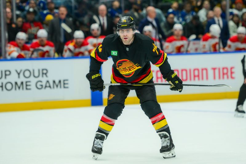 Nov 23, 2025; Vancouver, British Columbia, CAN;  Vancouver Canucks left wing Jake Debrusk (74) looks on during the first period against the Calgary Flames at Rogers Arena. Mandatory Credit: Simon Fearn-Imagn Images