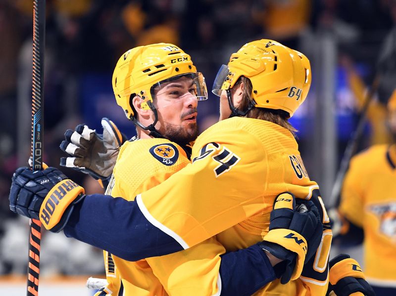 Jan 21, 2023; Nashville, Tennessee, USA; Nashville Predators defenseman Alexandre Carrier (45) celebrates after assisting on a goal by center Mikael Granlund (64) during the first period against the Los Angeles Kings at Bridgestone Arena. Mandatory Credit: Christopher Hanewinckel-USA TODAY Sports