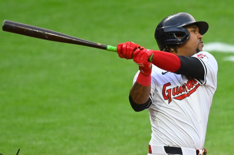 May 6, 2024; Cleveland, Ohio, USA; Cleveland Guardians third baseman Jose Ramirez (11) hits a solo home run in the sixth inning against the Detroit Tigers at Progressive Field. Mandatory Credit: David Richard-USA TODAY Sports