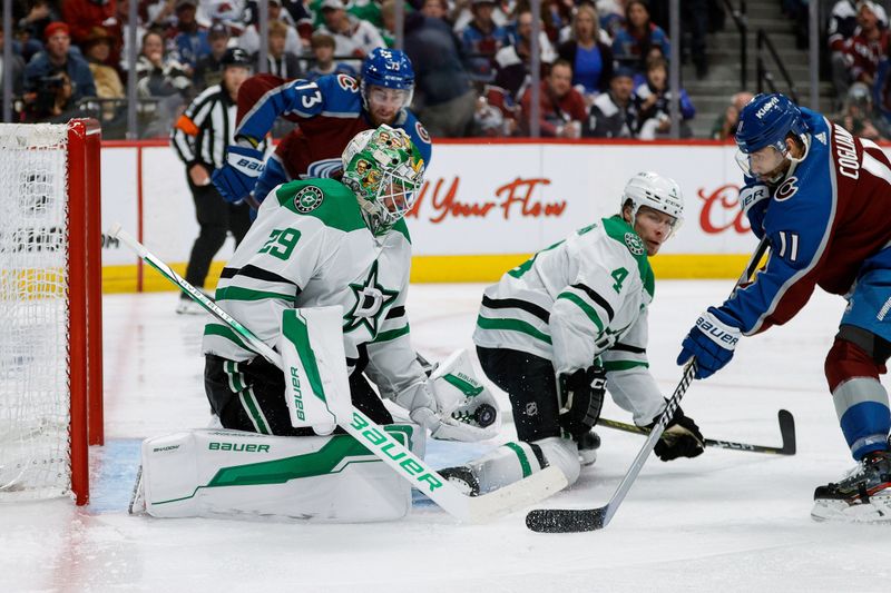 May 11, 2024; Denver, Colorado, USA; Dallas Stars goaltender Jake Oettinger (29) makes a save against Colorado Avalanche center Andrew Cogliano (11) as defenseman Miro Heiskanen (4) defends in the second period in game three of the second round of the 2024 Stanley Cup Playoffs at Ball Arena. Mandatory Credit: Isaiah J. Downing-USA TODAY Sports