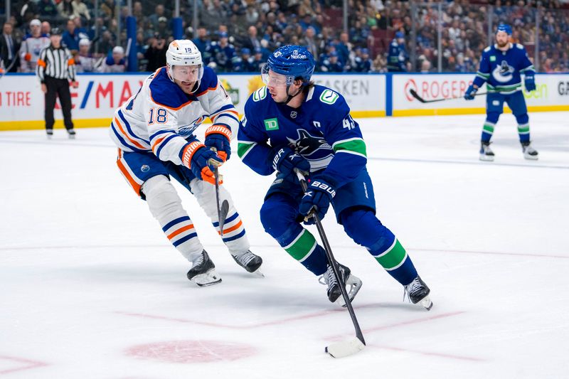 Oct 4, 2024; Vancouver, British Columbia, CAN; Vancouver Canucks defenseman Quinn Hughes (43) drives past Edmonton Oilers forward Zach Hyman (18) during the third period at Rogers Arena. Mandatory Credit: Bob Frid-Imagn Images