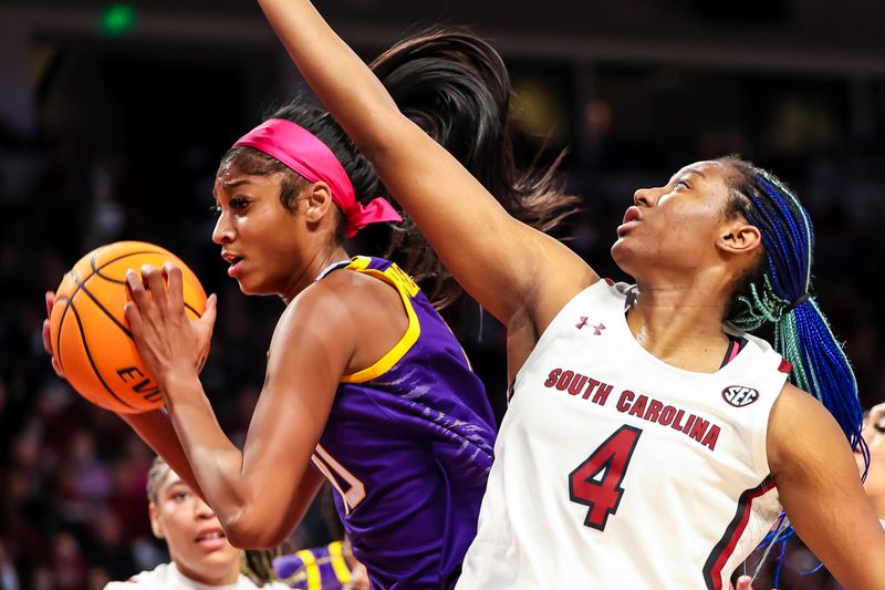 Feb 12, 2023; Columbia, South Carolina, USA; LSU Lady Tigers forward Angel Reese (10) grabs a rebound from South Carolina Gamecocks forward Aliyah Boston (4) in the first half at Colonial Life Arena. Mandatory Credit: Jeff Blake-USA TODAY Sports