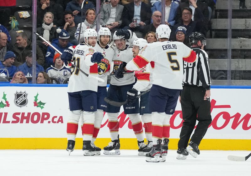 Nov 28, 2023; Toronto, Ontario, CAN; Florida Panthers center Kevin Stenlund (82) scores a goal and celebrates with Florida Panthers defenseman Oliver Ekman-Larsson (91) against the Toronto Maple Leafs during the first period at Scotiabank Arena. Mandatory Credit: Nick Turchiaro-USA TODAY Sports