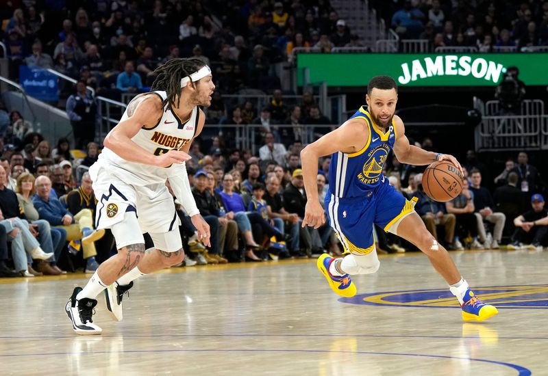 SAN FRANCISCO, CALIFORNIA - FEBRUARY 25: Stephen Curry #30 of the Golden State Warriors dribbling the ball is guarded by Aaron Gordon #50 of the Denver Nuggets during the third quarter of an NBA basketball game at Chase Center on February 25, 2024 in San Francisco, California. NOTE TO USER: User expressly acknowledges and agrees that, by downloading and or using this photograph, User is consenting to the terms and conditions of the Getty Images License Agreement. (Photo by Thearon W. Henderson/Getty Images)