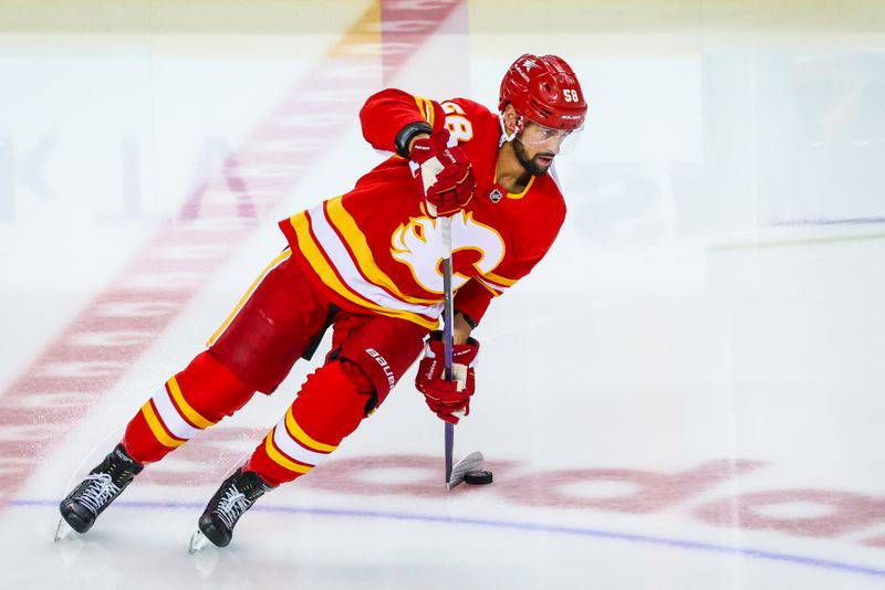 Apr 18, 2024; Calgary, Alberta, CAN; Calgary Flames defenseman Oliver Kylington (58) skates with the puck during the warmup period against the San Jose Sharks at Scotiabank Saddledome. Mandatory Credit: Sergei Belski-USA TODAY Sports