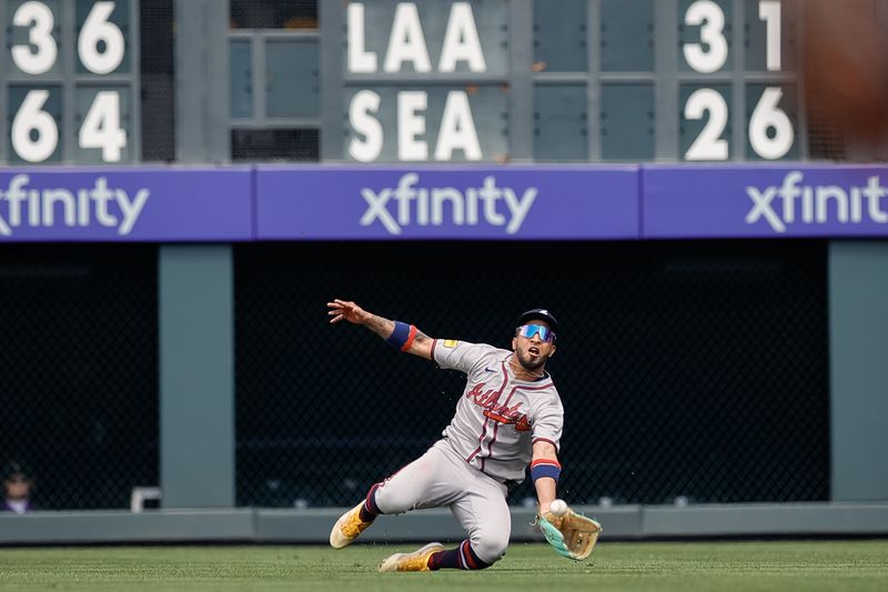 Apr 30, 2025; Denver, Colorado, USA; Atlanta Braves right field Eddie Rosario (9) makes a catch for an out in the third inning against the Colorado Rockies at Coors Field. Mandatory Credit: Isaiah J. Downing-Imagn Images