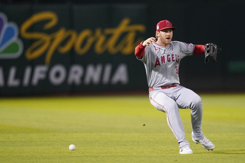 Jul 19, 2024; Oakland, California, USA; Los Angeles Angels left fielder Taylor Ward (3) commits an error against the Oakland Athletics in the sixth inning at Oakland-Alameda County Coliseum. Mandatory Credit: Cary Edmondson-USA TODAY Sports