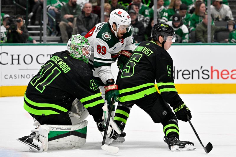 Jan 10, 2024; Dallas, Texas, USA; Dallas Stars defenseman Nils Lundkvist (5) blocks a shot in front of goaltender Scott Wedgewood (41) and Minnesota Wild center Frederick Gaudreau (89) during the third period at the American Airlines Center. Mandatory Credit: Jerome Miron-USA TODAY Sports