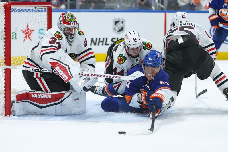 Apr 2, 2024; Elmont, New York, USA; New York Islanders left wing Anders Lee (27) attempts to take a shot on Chicago Blackhawks goaltender Petr Mrazek (34) during the second period at UBS Arena. Mandatory Credit: Thomas Salus-USA TODAY Sports