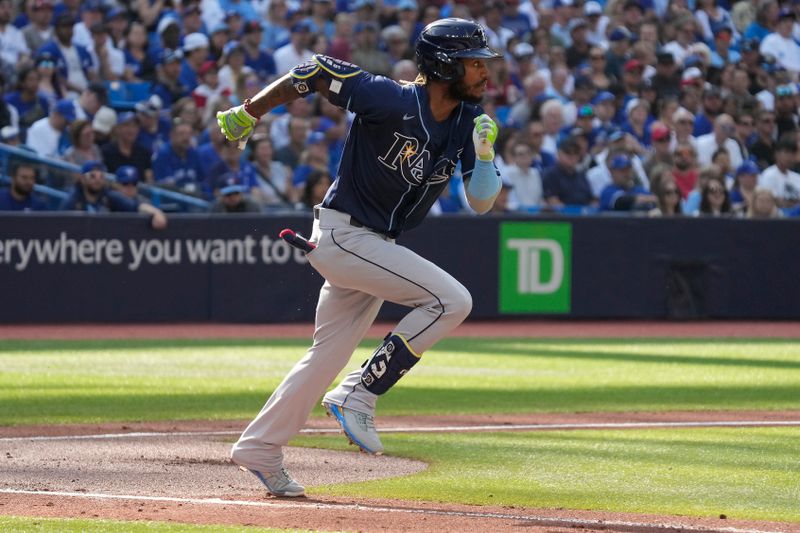 Oct 1, 2023; Toronto, Ontario, CAN; Tampa Bay Rays left fielder Raimel Tapia (10) singles against the Toronto Blue Jays during the second inning at Rogers Centre. Mandatory Credit: John E. Sokolowski-USA TODAY Sports