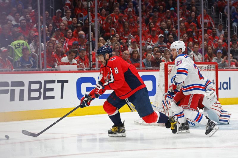 Apr 28, 2024; Washington, District of Columbia, USA; Washington Capitals left wing Alex Ovechkin (8) reaches for the puck as New York Rangers defenseman Adam Fox (23) defends in the first period in game four of the first round of the 2024 Stanley Cup Playoffs at Capital One Arena. Mandatory Credit: Geoff Burke-USA TODAY Sports