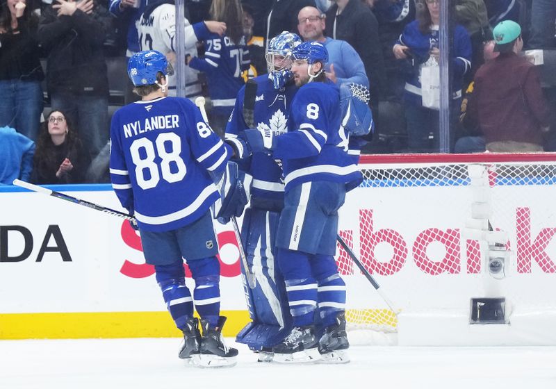 Nov 5, 2024; Toronto, Ontario, CAN; Toronto Maple Leafs goaltender Anthony Stolarz (41) celebrates the shoutout win with right wing William Nylander (88) against the Boston Bruins at the end of  the third period at Scotiabank Arena. Mandatory Credit: Nick Turchiaro-Imagn Imagess