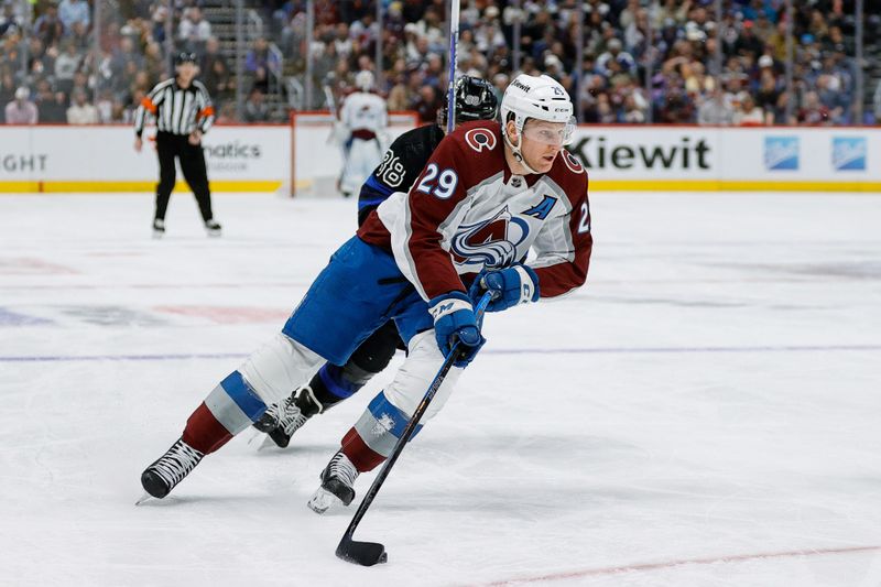 Feb 24, 2024; Denver, Colorado, USA; Colorado Avalanche center Nathan MacKinnon (29) controls the puck ahead of Toronto Maple Leafs right wing William Nylander (88) in the second period at Ball Arena. Mandatory Credit: Isaiah J. Downing-USA TODAY Sports