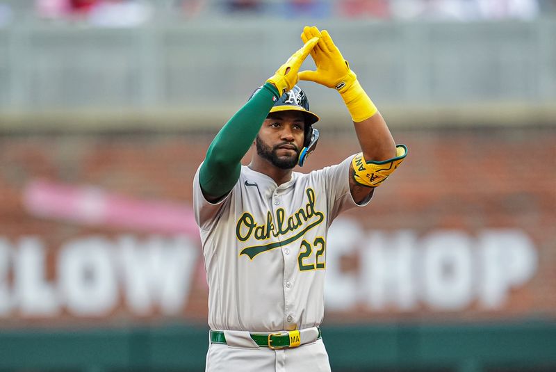 May 31, 2024; Cumberland, Georgia, USA; Oakland Athletics left fielder Miguel Andujar (22) reacts after hitting a double against the Atlanta Braves during the second inning at Truist Park. Mandatory Credit: Dale Zanine-USA TODAY Sports