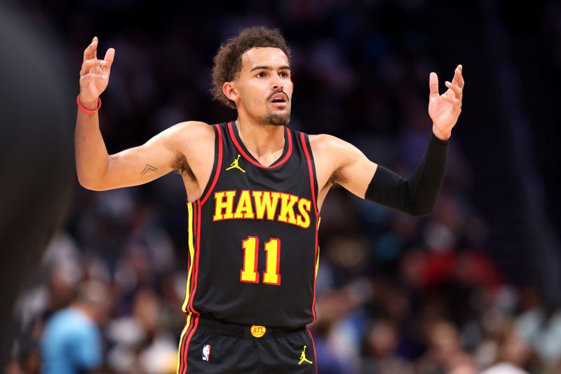 CHARLOTTE, NORTH CAROLINA - OCTOBER 25: Trae Young #11 of the Atlanta Hawks reacts to a call during the first half of a basketball game against the Charlotte Hornets at Spectrum Center on October 25, 2023 in Charlotte, North Carolina. NOTE TO USER: User expressly acknowledges and agrees that, by downloading and or using this photograph, User is consenting to the terms and conditions of the Getty Images License Agreement. (Photo by David Jensen/Getty Images)