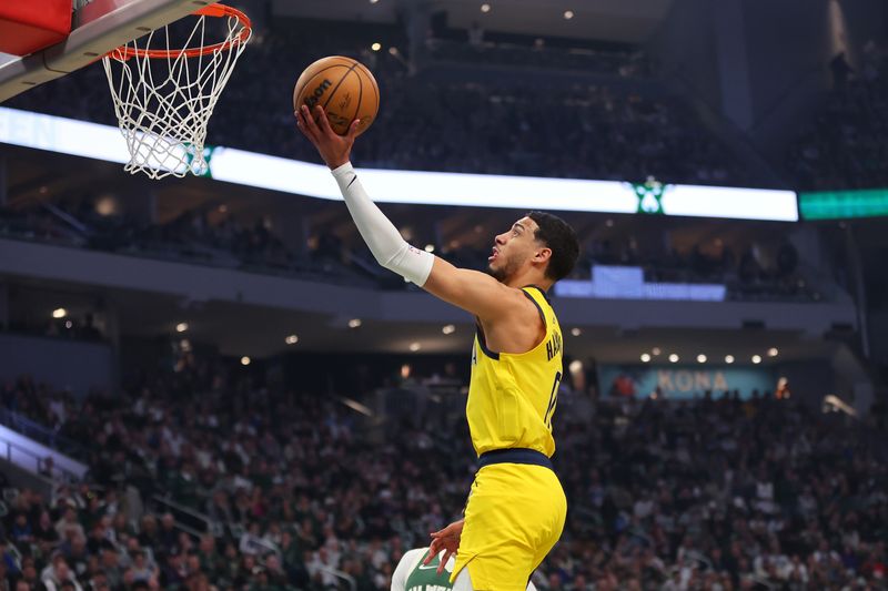 MILWAUKEE, WISCONSIN - APRIL 21: Tyrese Haliburton #0 of the Indiana Pacers drives to the basket against the Milwaukee Bucks during the first half  of game one of the Eastern Conference First Round Playoffs at Fiserv Forum on April 21, 2024 in Milwaukee, Wisconsin.  NOTE TO USER: User expressly acknowledges and agrees that, by downloading and or using this photograph, User is consenting to the terms and conditions of the Getty Images License Agreement. (Photo by Stacy Revere/Getty Images)