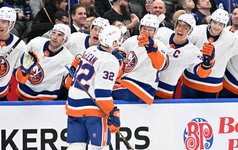 Feb 5, 2024; Toronto, Ontario, CAN;   New York Islanders forward Kyle MacLean (32) celebrates with team mates at the bench after scoring a goal against the Toronto Maple Leafs goalie in the second period at Scotiabank Arena. Mandatory Credit: Dan Hamilton-USA TODAY Sports