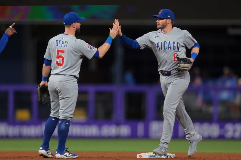 May 20, 2025; Miami, Florida, USA; Chicago Cubs left fielder Ian Happ (8) celebrates with second baseman Jon Berti (5) after the game against the Miami Marlins at loanDepot Park. Mandatory Credit: Sam Navarro-Imagn Images