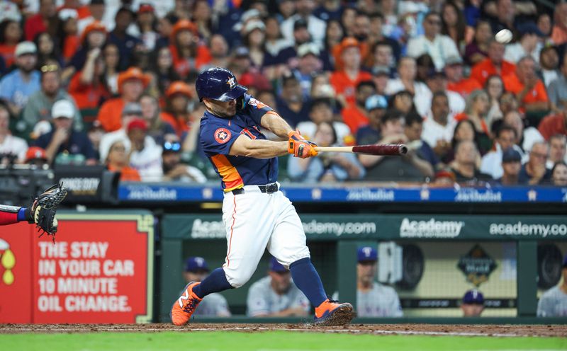 Apr 14, 2024; Houston, Texas, USA; Houston Astros second baseman Jose Altuve (27) hits a home run during the third inning against the Texas Rangers at Minute Maid Park. Mandatory Credit: Troy Taormina-USA TODAY Sports