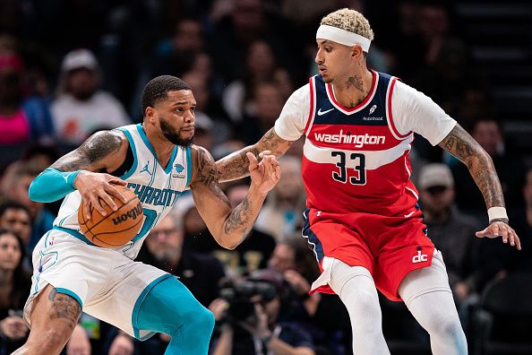 CHARLOTTE, NORTH CAROLINA - NOVEMBER 22: Kyle Kuzma #33 of the Washington Wizards guards Miles Bridges #0 of the Charlotte Hornets in the first quarter during their game at Spectrum Center on November 22, 2023 in Charlotte, North Carolina. NOTE TO USER: User expressly acknowledges and agrees that, by downloading and or using this photograph, User is consenting to the terms and conditions of the Getty Images License Agreement. (Photo by Jacob Kupferman/Getty Images)