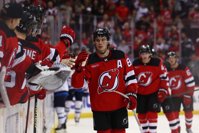 Mar 21, 2024; Newark, New Jersey, USA; New Jersey Devils center Jack Hughes (86) celebrates his goal against the Winnipeg Jets during the third period at Prudential Center. Mandatory Credit: Ed Mulholland-USA TODAY Sports