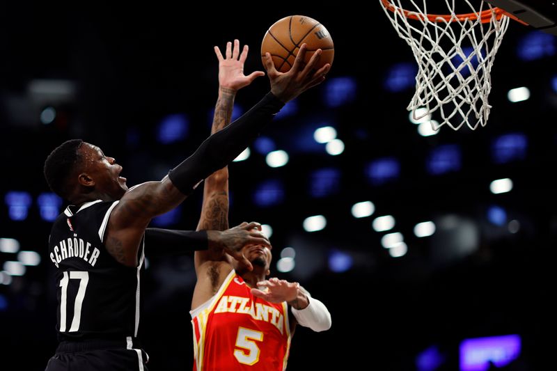 NEW YORK, NEW YORK - MARCH 02: Dennis Schroder #17 of the Brooklyn Nets goes to the basket as Dejounte Murray #5 of the Atlanta Hawks defends during the first half at Barclays Center on March 02, 2024 in the Brooklyn borough of New York City. NOTE TO USER: User expressly acknowledges and agrees that, by downloading and or using this photograph, User is consenting to the terms and conditions of the Getty Images License Agreement. (Photo by Sarah Stier/Getty Images)