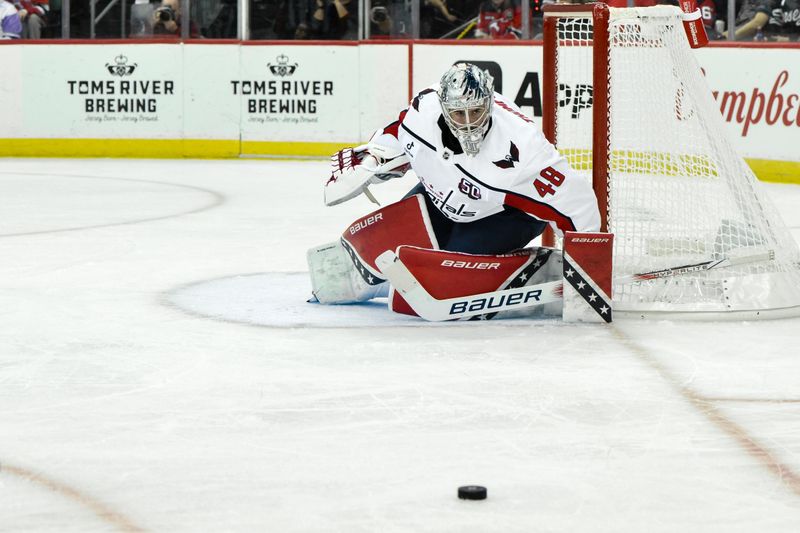 Oct 19, 2024; Newark, New Jersey, USA; Washington Capitals goaltender Logan Thompson (48) watches the puck during the second period against the New Jersey Devils at Prudential Center. Mandatory Credit: John Jones-Imagn Images