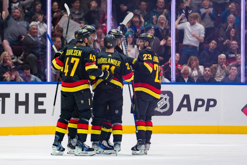 Feb 15, 2024; Vancouver, British Columbia, CAN; Vancouver Canucks defenseman Nikita Zadorov (91) and  defenseman Noah Juulsen (47) and forward Nils Hoglander (21) and forward Elias Pettersson (40) and forward Elias Lindholm (23) celebrate Zadorov s goal against the Detroit Red Wings in the second period at Rogers Arena. Mandatory Credit: Bob Frid-USA TODAY Sports