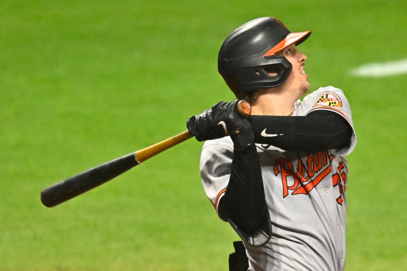 Sep 21, 2023; Cleveland, Ohio, USA; Baltimore Orioles catcher Adley Rutschman (35) hits a double in the eighth inning against the Cleveland Guardians at Progressive Field. Mandatory Credit: David Richard-USA TODAY Sports