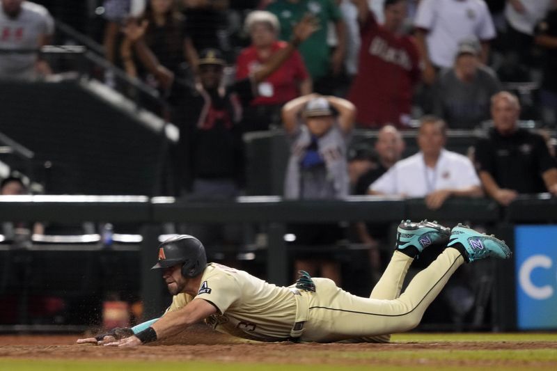 Sep 16, 2023; Phoenix, Arizona, USA; Arizona Diamondbacks pinch hitter Evan Longoria (3) slides at home and scores the game winning run against the Chicago Cubs during the 13th inning at Chase Field. Mandatory Credit: Joe Camporeale-USA TODAY Sports