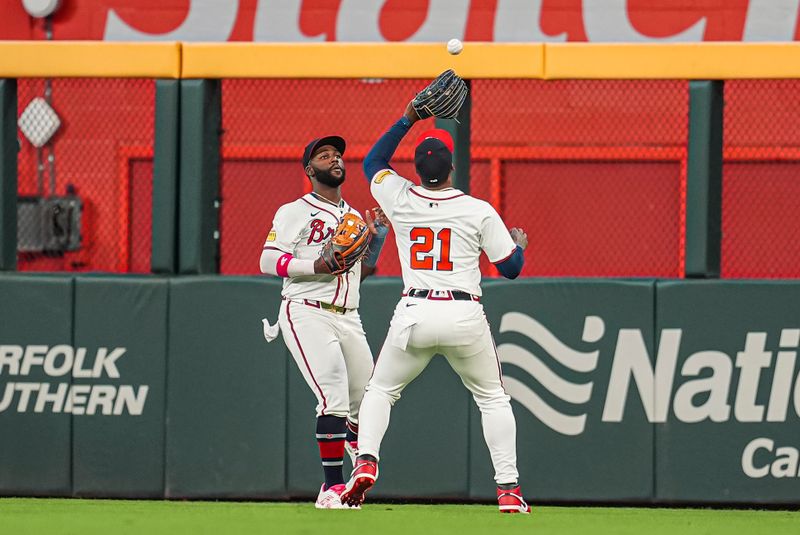 Sep 15, 2024; Cumberland, Georgia, USA; Atlanta Braves right fielder Jorge Soler (21) waits for the ball hit by Los Angeles Dodgers catcher Will Smith (16) (not pictured) to come off the top of the right field wall for a triple  during the ninth inning at Truist Park. Mandatory Credit: Dale Zanine-Imagn Images