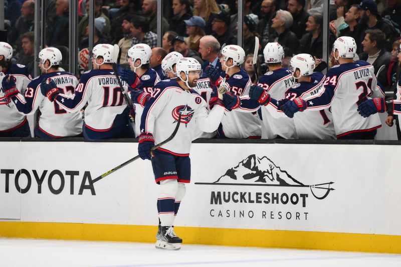 Nov 12, 2024; Seattle, Washington, USA; Columbus Blue Jackets center Zachary Aston-Reese (27) celebrates with the bench after scoring a goal against the Seattle Kraken during the first period at Climate Pledge Arena. Mandatory Credit: Steven Bisig-Imagn Images