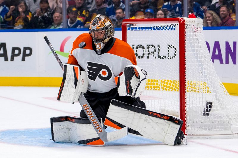 Oct 11, 2024; Vancouver, British Columbia, CAN; Philadelphia Flyers goalie Samuel Ersson (33) makes a save against the Vancouver Canucks during the third period at Rogers Arena. Mandatory Credit: Bob Frid-Imagn Images