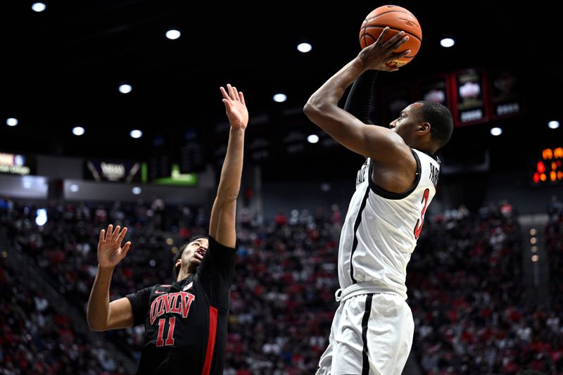 Jan 6, 2024; San Diego, California, USA; San Diego State Aztecs guard Micah Parrish (3) shoots the ball over UNLV Rebels guard Dedan Thomas Jr. (11) during the first half at Viejas Arena. Mandatory Credit: Orlando Ramirez-USA TODAY Sports