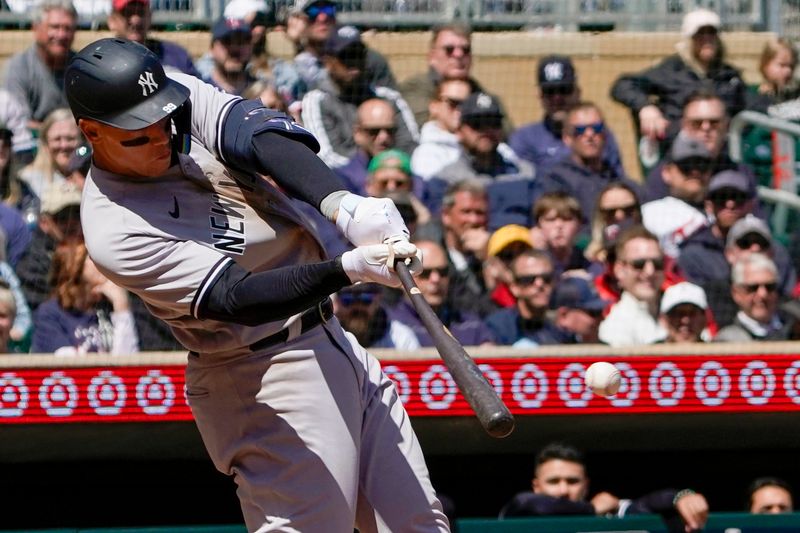 Apr 26, 2023; Minneapolis, Minnesota, USA; New York Yankees designated hitter Aaron Judge (99) hits a single against the Minnesota Twins during the fifth inning at Target Field. Mandatory Credit: Nick Wosika-USA TODAY Sports

