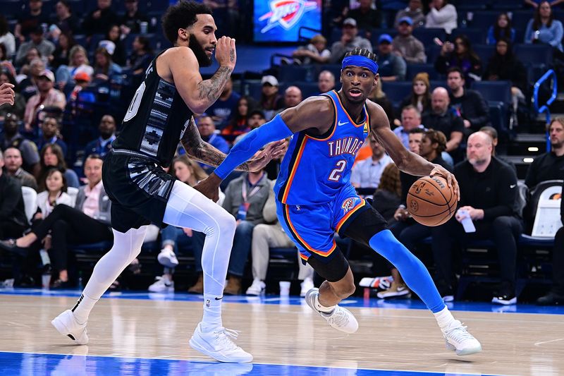 OKLAHOMA CITY, OKLAHOMA - APRIL 10: Shai Gilgeous-Alexander #2 of the Oklahoma City Thunder drives against Julian Champagnie #30 of the San Antonio Spurs during the second half at Paycom Center on April 10, 2024 in Oklahoma City, Oklahoma. NOTE TO USER: User expressly acknowledges and agrees that, by downloading and or using this Photograph, user is consenting to the terms and conditions of the Getty Images License Agreement. (Photo by Joshua Gateley/Getty Images)