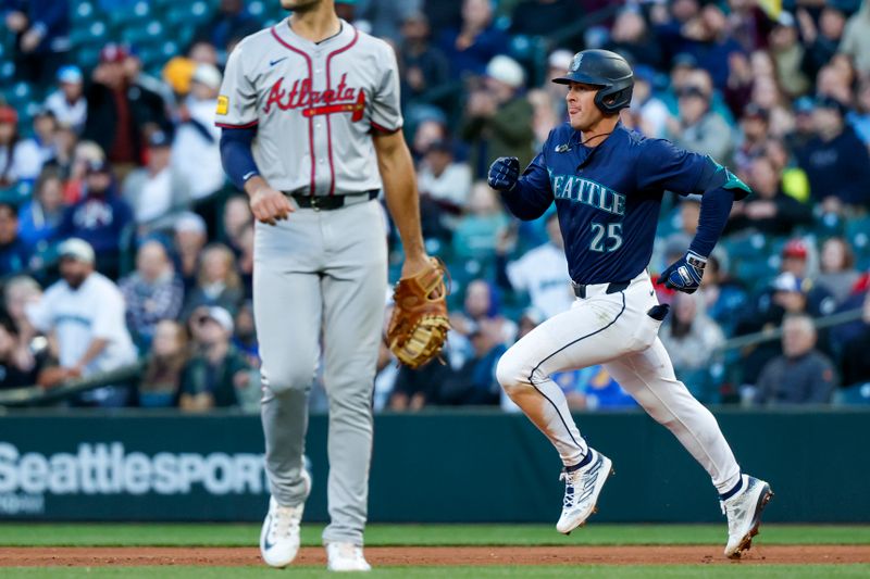 Apr 30, 2024; Seattle, Washington, USA; Seattle Mariners shortstop Dylan Moore (25) advance to second base for an RBI-double against the Atlanta Braves during the fourth inning at T-Mobile Park. Mandatory Credit: Joe Nicholson-USA TODAY Sports