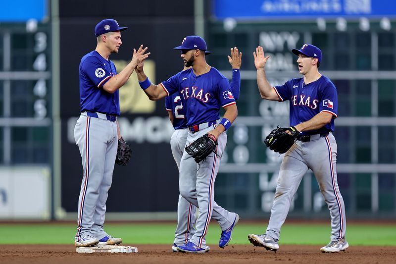 Jul 13, 2024; Houston, Texas, USA; Texas Rangers congratulate each other after the final out against the Houston Astros during the tenth inning at Minute Maid Park. Mandatory Credit: Erik Williams-USA TODAY Sports