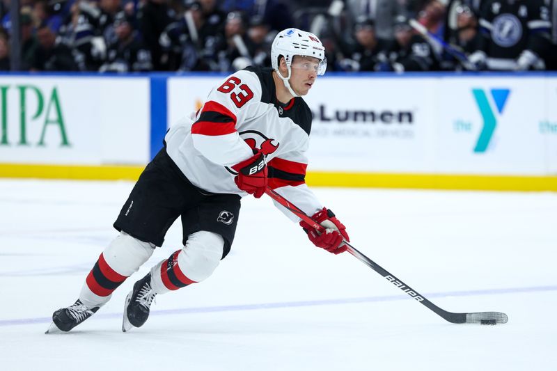 Nov 16, 2024; Tampa, Florida, USA; New Jersey Devils left wing Jesper Bratt (63) controls the puck against the Tampa Bay Lightning in the second period at Amalie Arena. Mandatory Credit: Nathan Ray Seebeck-Imagn Images