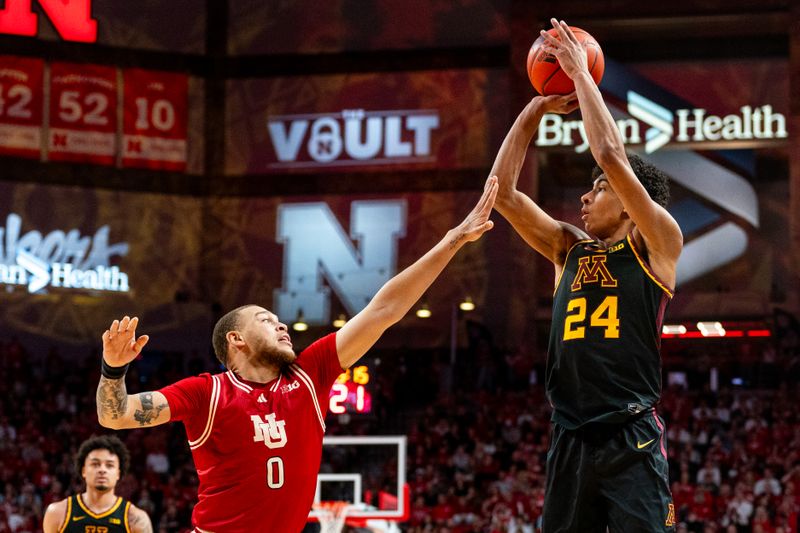 Feb 25, 2024; Lincoln, Nebraska, USA; Minnesota Golden Gophers guard Cam Christie (24) shoots a three-point shot against Nebraska Cornhuskers guard C.J. Wilcher (0) during the second half at Pinnacle Bank Arena. Mandatory Credit: Dylan Widger-USA TODAY Sports